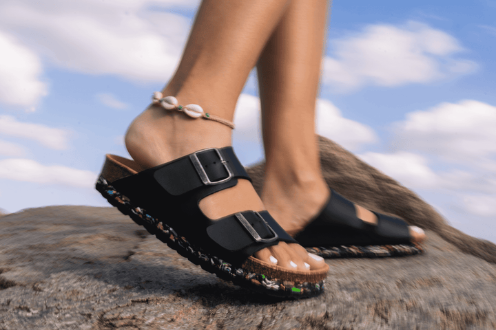 closeup of someone walking with Nuoceans sandals on a rock 