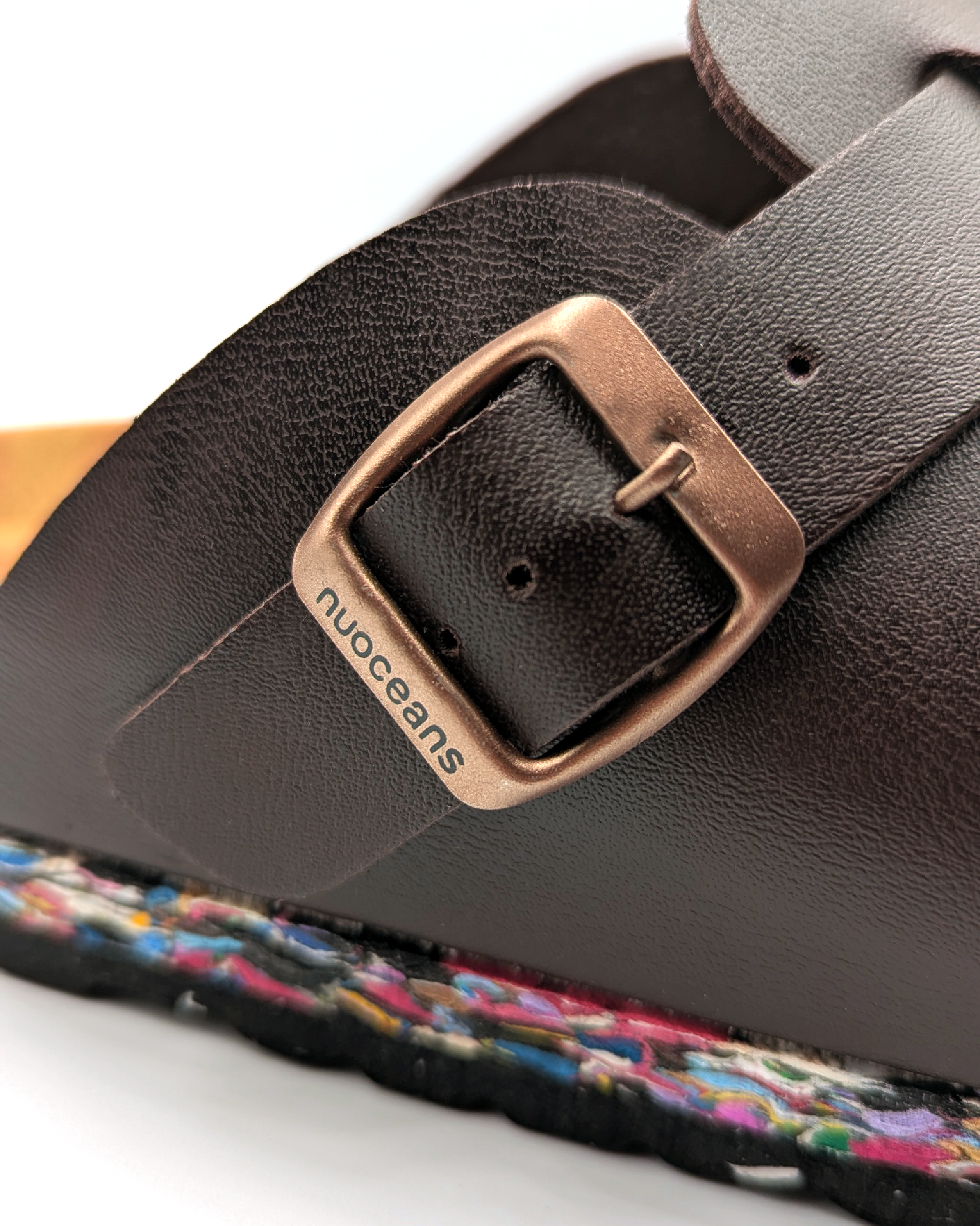 Sustainable Darkbrown nuoceans nuos clog with a buckle and colorful sole made from coean waste on a white background